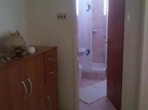 a bathroom with a shower and a sink and a toilet at Apartmani Borić in Orebić