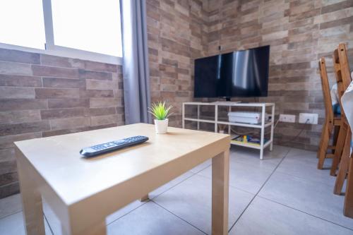 a living room with a table with a remote control on it at Edificio Prieto VIV 5 in Puerto del Rosario