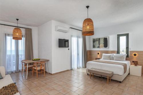 a hotel room with a bed and a table at Arlen Beach Hotel in Hersonissos