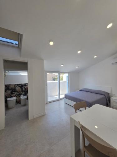 a bedroom with a bed and a dining room with a table at Dimore Marche Porto Recanati in Porto Recanati
