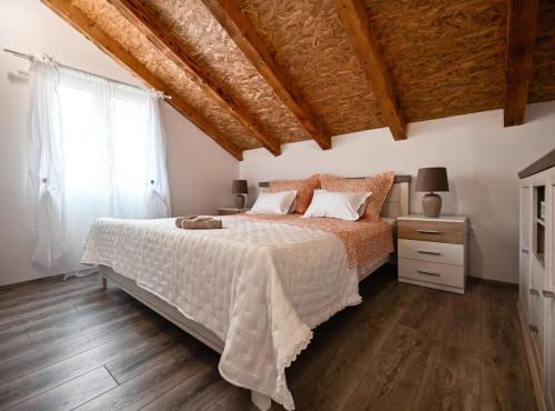 a bedroom with a bed and a wooden floor at La Felicita in Gornji Zemunik