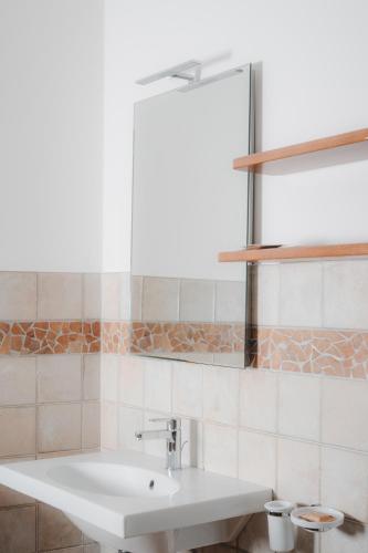 a bathroom with a white sink and a mirror at Agriturismo La Valle Di Vico in Caprarola