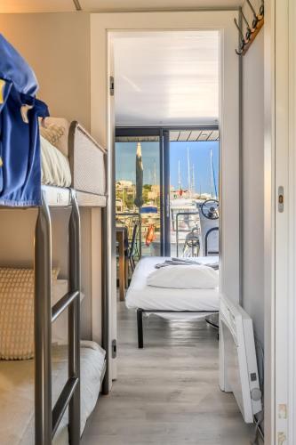 a room with bunk beds and a view of a boat at The Homeboat Company Albufeira in Albufeira