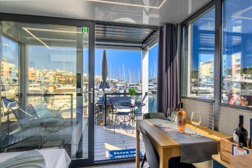 a balcony with a table and a view of a marina at The Homeboat Company Albufeira in Albufeira