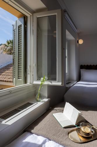 a room with a window and a bed and a table at Once&Forever Estate in Athens