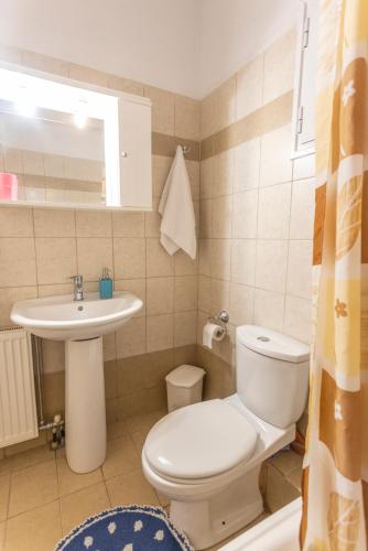 a bathroom with a toilet and a sink at Serene Villa in Kriopigi