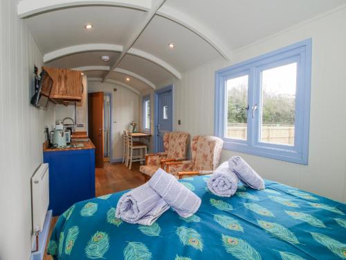 a bedroom with a blue bed with pillows on it at Skye in Ludlow