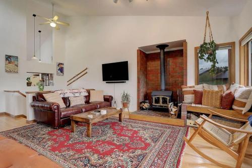 a living room with a couch and a fireplace at 534 Sun River #8 in Fraser