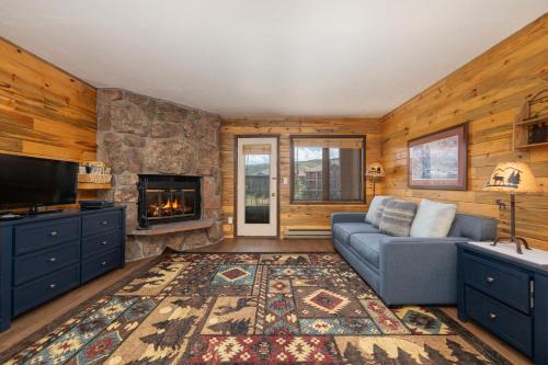 a living room with a couch and a fireplace at 564 Silvercreek Inn in Granby