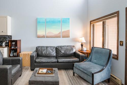 a living room with a couch and a chair at 643 Silvercreek Inn Condo in Granby