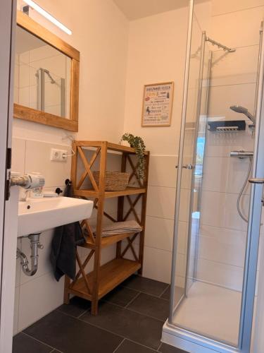 a bathroom with a sink and a shower at Artland Quartier Quakenbrück in Quakenbrück