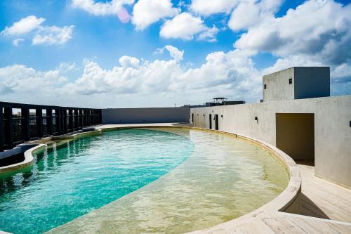 a swimming pool on the roof of a building at Jungle View Nest Selva Rooftop in Tulum