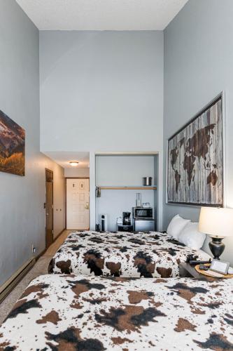 a bedroom with a large bed with a rug on it at 645 Silvercreek Inn Room in Granby