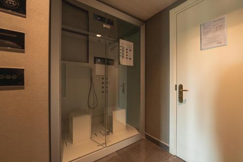 a glass door with a shower in a room at Hotel Forum in Pompei