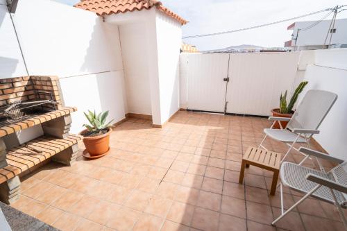 a balcony with a tile floor and white walls at Yesenia Vv Airport in El Matorral