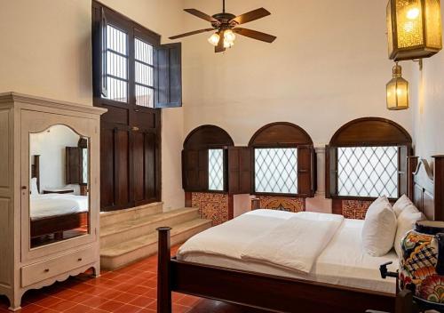 a bedroom with a bed and a ceiling fan at Villa Merida Luxury Mansion - Adults Only Boutique Hotel in Mérida