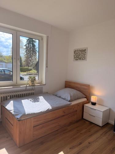 a bedroom with a large bed and a window at Artland Quartier Quakenbrück in Quakenbrück