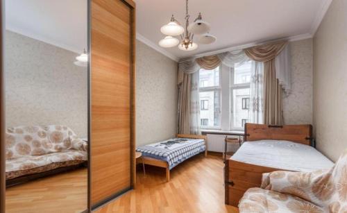 a bedroom with a mirror and a bed and a desk at City Centre Cozy Guesthouse in Riga