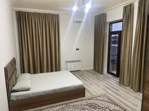 a bedroom with a bed and a window at Billa Sea breeze in Baku