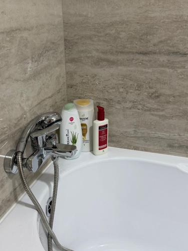 a bathroom sink with products sitting on top of it at Natalia Apart in Alba Iulia
