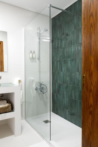 a shower with a glass door in a bathroom at Casa da Azenha in Peso da Régua