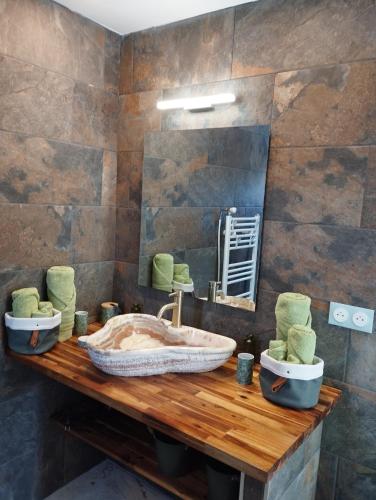 a bathroom with two sinks and a large mirror at Chambre 2 pers SPA Piscine in Grospierres
