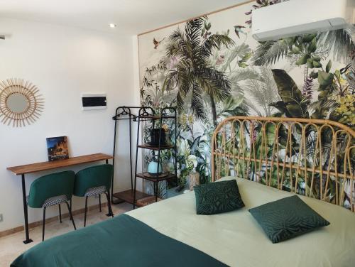 a bedroom with a bed and a mural of plants at Chambre 2 pers SPA Piscine in Grospierres