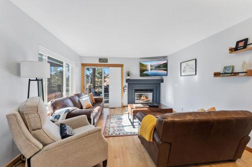 a living room with two couches and a fireplace at 820 Badger Ln in Fraser