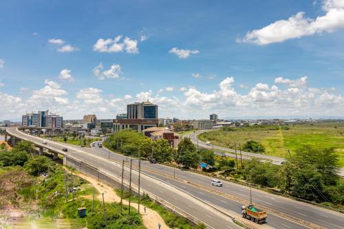 a highway with a city in the background at A Scenic Escape within Nairobi in Nairobi