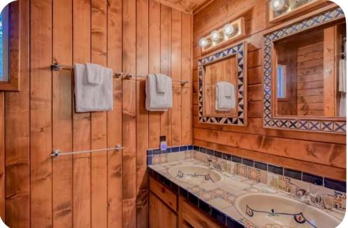 a bathroom with a tub and a sink and a mirror at Elevation Station Surrounded by Wildlife in Angel Fire