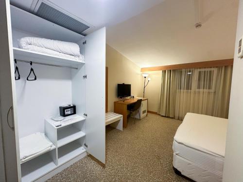 a bedroom with a bed and a desk with a computer at Trakya City Hotel in Edirne