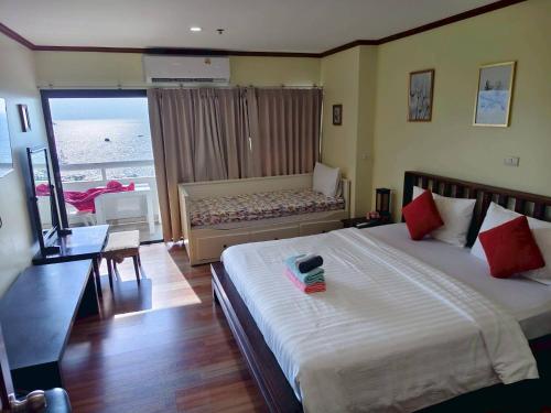a hotel room with two beds and a window at Patong Tower 2 Bedrooms Sea View Top Top in Patong Beach