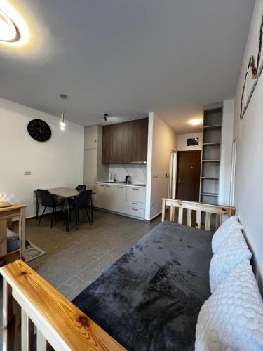 a living room with a bed and a kitchen at DEYA Apartment Becici in Boreti