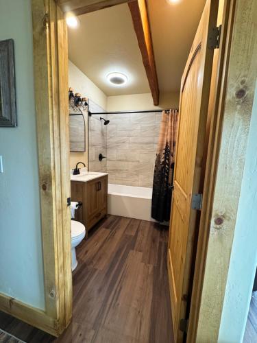 a bathroom with a tub and a toilet and a sink at Rustic Bay View Cabins- Lodge in Homer