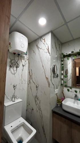 a bathroom with a toilet and a sink at Bee Home Stay in Greater Noida