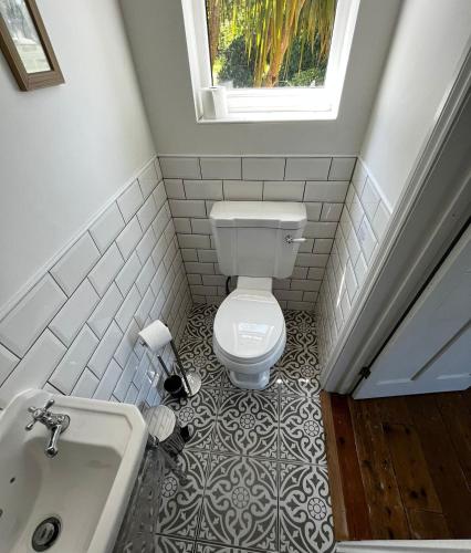 a bathroom with a toilet and a sink at Mill Villa Pakefield in Pakefield