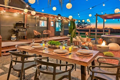 a patio with a wooden table and chairs and lights at Plant City Home and Guest House with Outdoor Pool! in Plant City