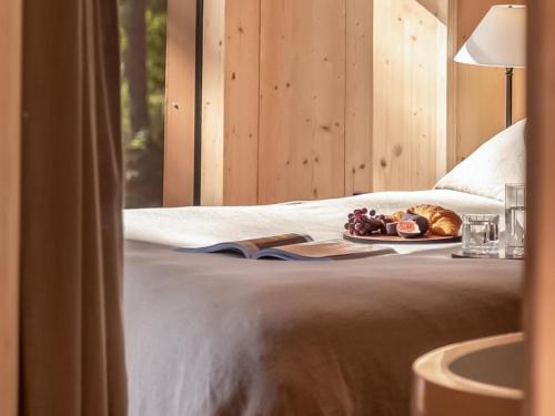 a bed with a plate of food and a book at Lady's Slipper-Qu7628 in Chipping Norton