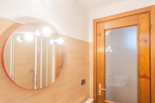 a bathroom with a mirror on the wall at Piccola Abbazia by RentAllComo in Lenno