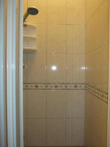 a bathroom with a tiled shower with a light at Verde Mare "Appartamenti Per Vacanze" in Tortoreto Lido