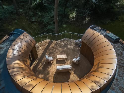 an overhead view of a circular patio with a table and benches at Liberty-Qu7629 in Chipping Norton