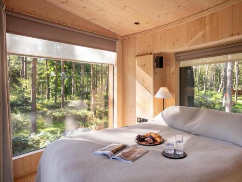 a bedroom with a bed and a large window at Liberty-Qu7629 in Chipping Norton
