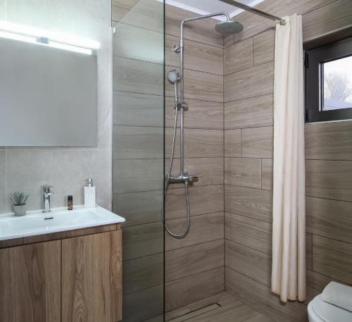a bathroom with a shower and a sink at Nefeli Rooms in Agia Marina Nea Kydonias