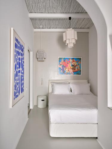 a white bedroom with a white bed in a room at Chiara Mykonos in Mikonos