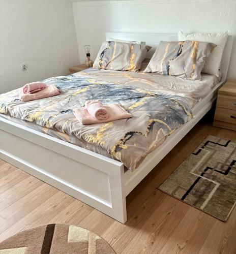 a bed with pink slippers on it in a bedroom at Philippos in Bujanovac