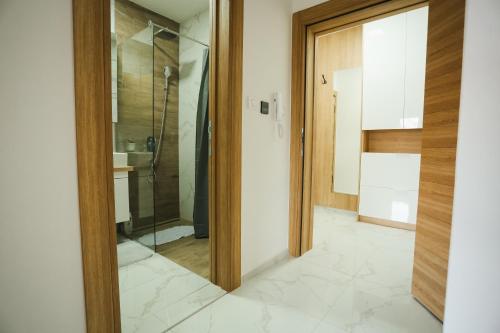 a bathroom with a shower and a glass door at BK Apartman in Zlatibor