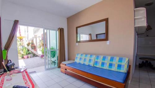 a bedroom with a blue bed and a mirror at Residencial Zirke in Florianópolis