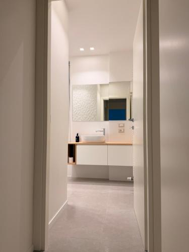 a kitchen with white cabinets and a sink at Da Nella 2 in Ancona