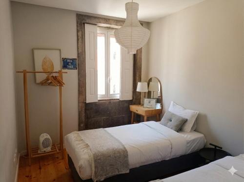 a bedroom with two beds and a window at Oporto City View - Santo Ildefonso in Porto