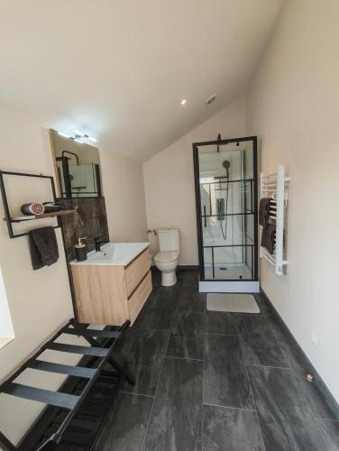 a bathroom with a sink and a toilet at Le Box Circuit Magny-Cours in Saint-Parize-le-Châtel